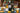Three wine bottles including a French Sauvignon Blanc, Douro Red and Tanners Prosecco, alongside two wine glasses on a decorated dining table with a plaid tablecloth, candles, olives, and a Christmas tree in the background.