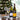 Two wine bottles and two glasses on a tray with a Christmas tree in the background