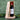 Rioja Vega wine bottle in a wooden stand with a green leafy background