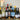 Collection of wine bottles on a table with candles and decorative items.