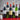Assorted wine bottles with labels on a red surface and gray background