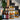 Assorted bottles of cider on a staircase with decorative elements.