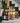 Assorted bottles of cider on a staircase with decorative elements.