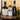Three bottles of Tanners spirits including a Sloe Gin, Sauternes and Vintage Port arranged on a decorative copper tray with lit candles and greenery in the background.
